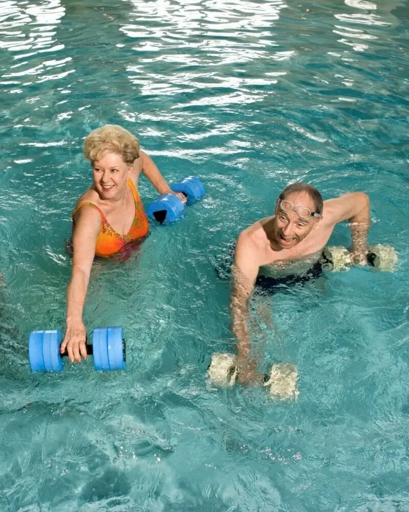 Elderly couple exercising in a swimming pool