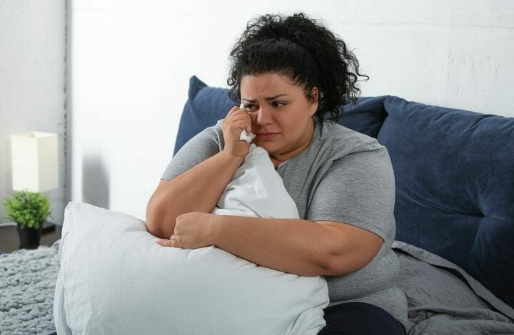 Depressed Overweight Woman Alone in Her Bedroom