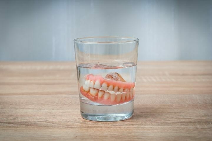 Dentures on glass of water