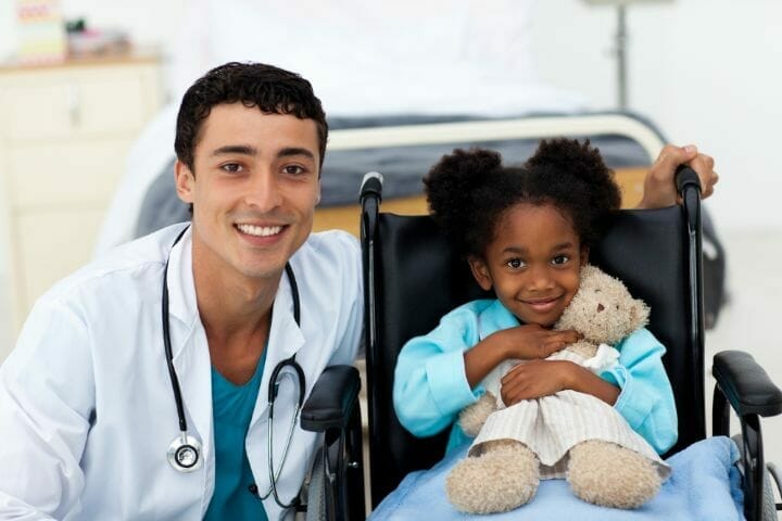 Doctor helping a sick kid in a wheelchair