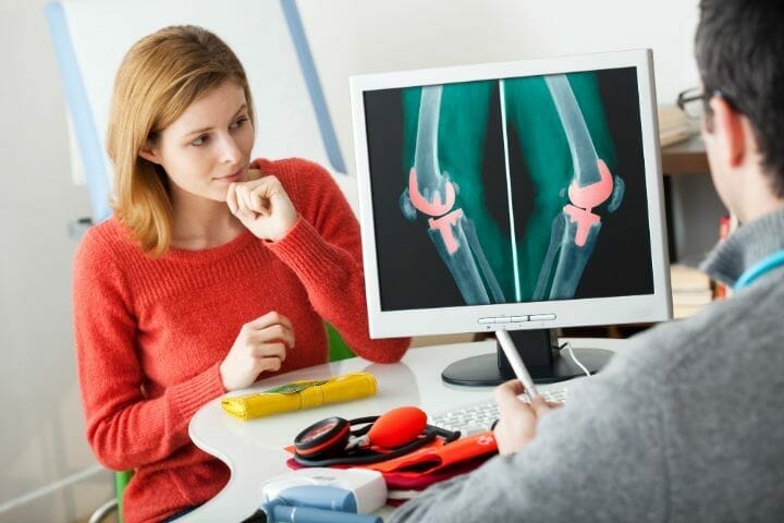 Doctor showing Knee Prosthetis Xray to a patient