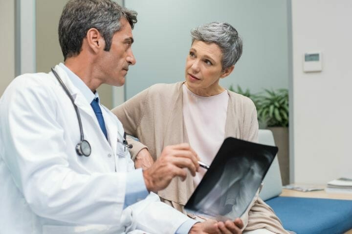 Doctor explaining the xray film to his patient