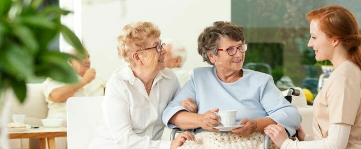 Two senior woman with caregiver