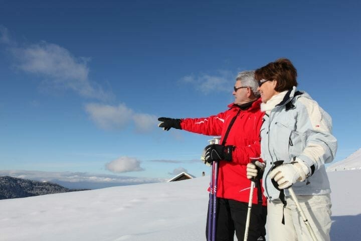 Lovely senior couple skiing together