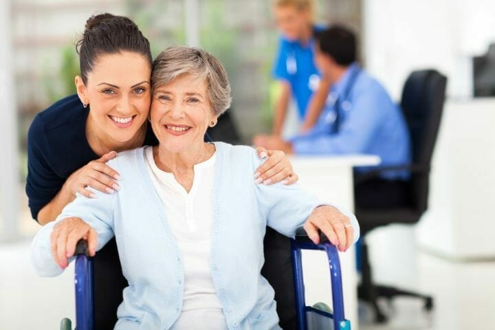 Caregiver accompanying senior woman to a doctor visit