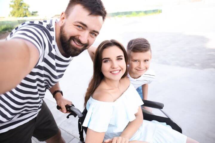 Paraplegic woman with her husband and son