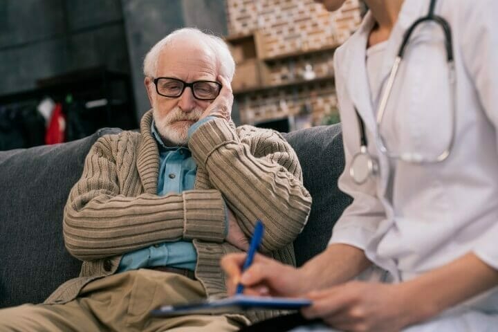 Old man looking at doctor's writing