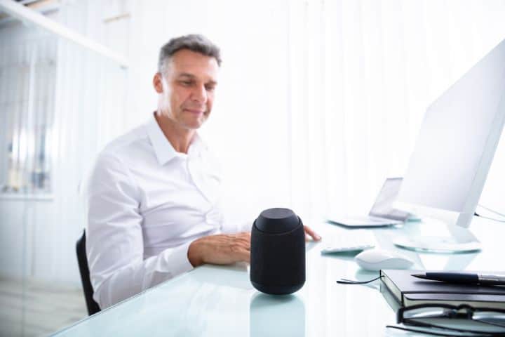 Sitting Man giving command to Alexa