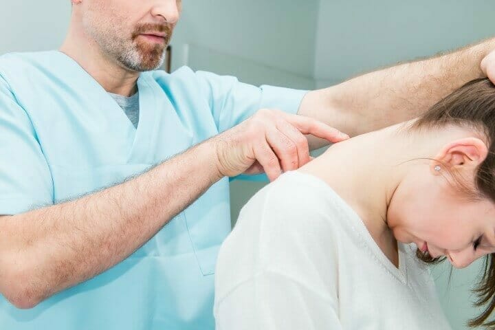 Doctor examining spinal cord of a patient