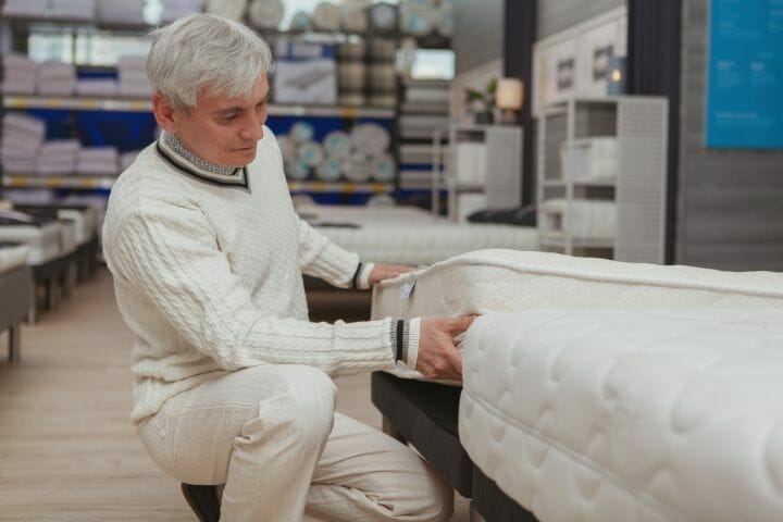 Senior man shopping for a mattress