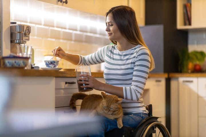 Woman in wheelchair having coffee