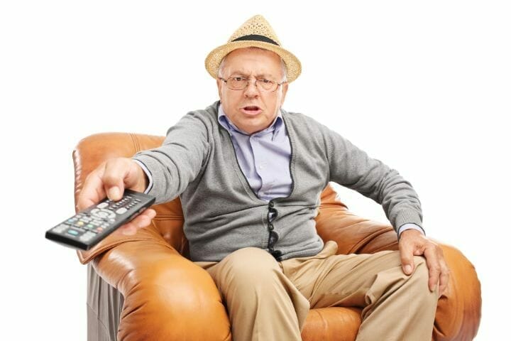 agitated senior holding a remote control