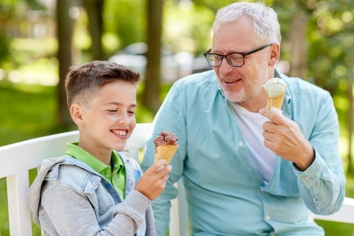 kid eating ice cream with his grandfather