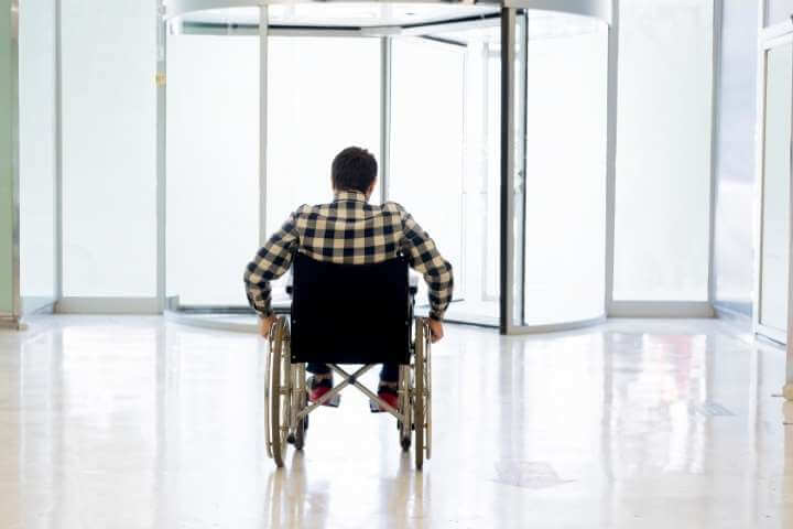 man on wheels with wide glass doors