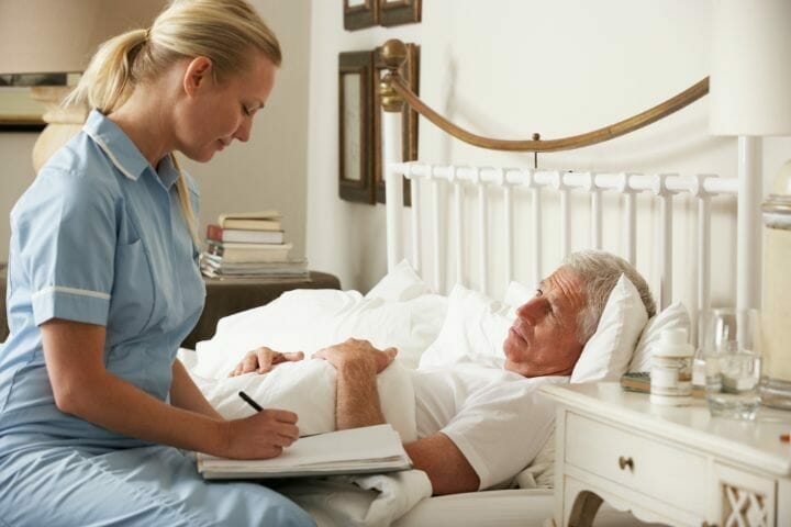 nurse taking record on male partient