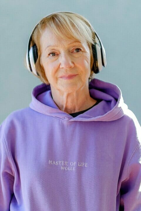 old lady listening to music on headphone