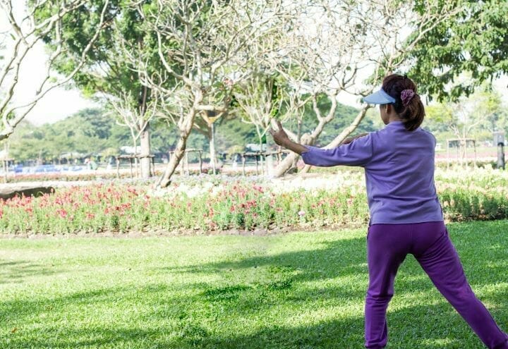 senior woman doing tai chi at the park