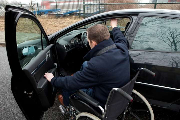 disabled man getting into his car