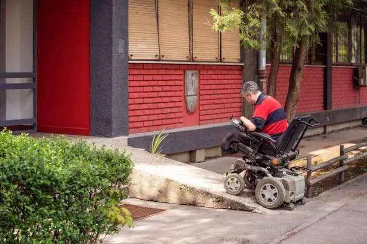 man on wheelchair entering the building