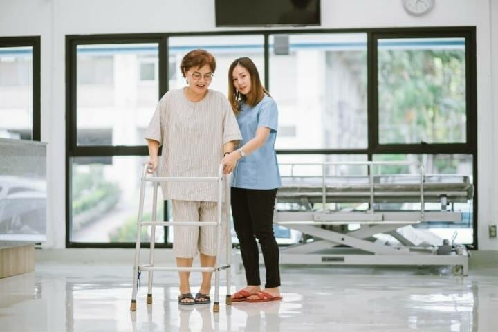 physical therapist and her patient with walker